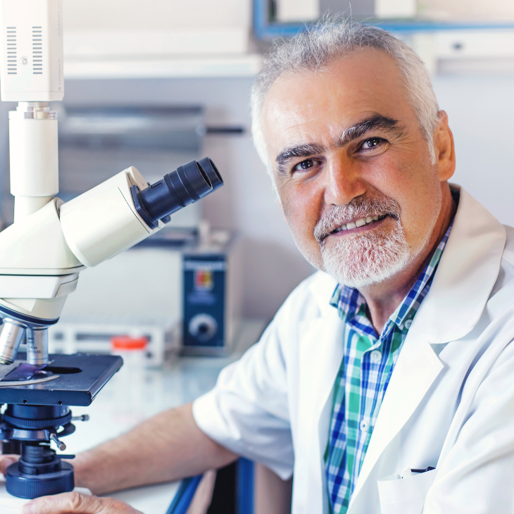 Laboratory educator sitting in front of a microscope